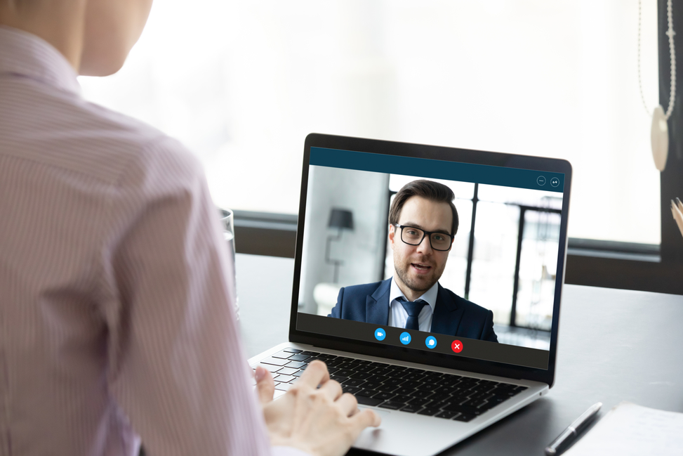 Female employee have video call with business partner Female employee talking with male colleague or business partner using virtual video call on laptop